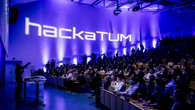 Crowded lecture hall at hackaTUM 2025.
