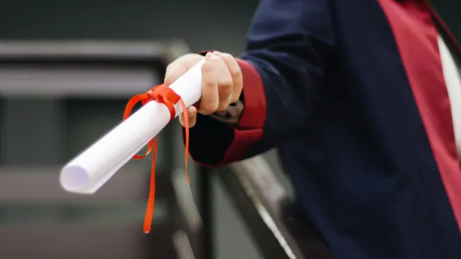 Graduation abroad: Person with white scroll