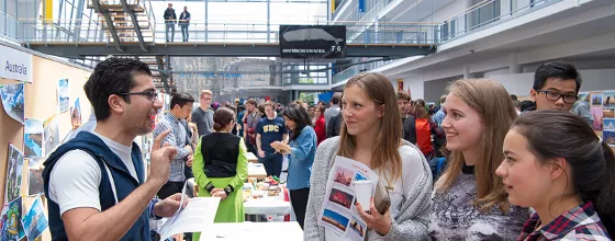 International Day 2016: Students talking to each other at a booth.